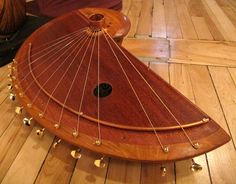 a wooden instrument sitting on top of a hard wood floor