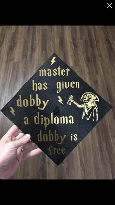 a graduation cap with the words master has given dobby, adploma, dobby is free