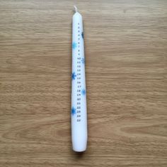 a white toothbrush sitting on top of a wooden table