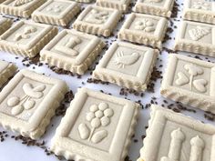 some cookies are arranged on a table with coffee beans scattered around them and decorated like squares