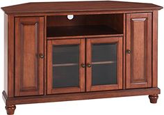 a wooden entertainment center with glass doors