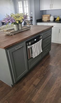 a kitchen island with an oven and dishwasher