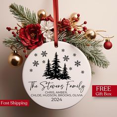 a personalized christmas ornament with pine trees and snowflakes on it