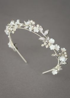 a tiara with white flowers and pearls