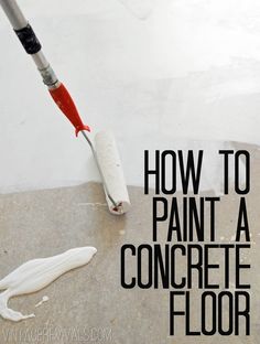 a white floor with a red and black paint roller on top of it next to a concrete floor