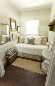 a bedroom with a white bed and pillows