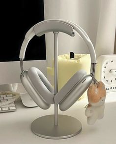 a computer desk with headphones on it