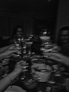 black and white photograph of people holding wine glasses