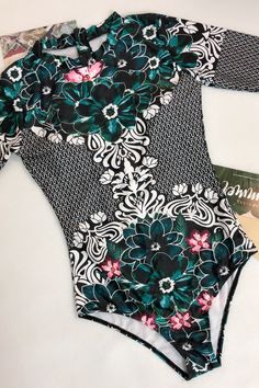 Ethnic one piece swimsuit featuring stand collar, long sleeve and zip back, brief cut leg design and floral printSize Guide:Size (in)USBustWaistHipS4-632-3424-2634-36M8-1034-3626-2836-38L12-1436-3828-3038-40XL1638-4030-3240-42 Stretch Floral Print Swimwear For Surfing, Long Sleeve Floral Print Stretch Swimwear, Long Sleeve Floral Print Swimwear For Surfing, Green Long Sleeve Bodysuit For Beach, Green Long Sleeve Bodysuit For The Beach, Multicolor Long Sleeve Swimwear For Pool, Long Sleeve Floral Print Swimwear For Beach Season, Long Sleeve Tropical Print Swimwear, Long Sleeve Tropical Print Beachwear