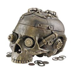 Celebrate the adventurous spirit of the age of Steampunk with our industrial age skeleton containment vessel that flips its Victorian skull lid to hold your vintage treasures! Fraught with a drill chuck, steam valve and intertwined gears, our Design Toscano creatively embellished designer resin work of decorative art boasts a faux oxidized brass finish for true authenticity. 7½"Wx6"Dx5½"H. 1 lb. Skull Figurines, Décor Steampunk, Steampunk Medieval, Gothic Gloves, Steampunk Hats, Diy Steampunk, Steampunk Skull, Sell Ideas, Steampunk Theme