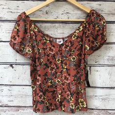 Adorable Short Top Has Buttons Down The Front & Elastic Around Sleeves And Back Of Neckline Cinched Elastic With Stitching In The Back Hem Is Slightly Curved In Front & Straight In Back Beautiful Pattern New With Tags! Brown Printed Summer Tops, Casual Printed Orange Tops, Casual Brown Floral Print Tops, Orange Short Sleeve Casual Blouse, Casual Short Sleeve Orange Blouse, Orange Casual Short Sleeve Blouse, Casual Orange Printed Blouse, Casual Orange Short Sleeve Blouse, Fitted Casual Orange Blouse