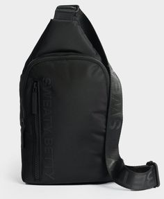 a black shoulder bag sitting on top of a white surface