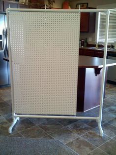 a kitchen with a large white board on the floor