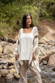 Introducing the TAIKI Light Poncho Top, a one-of-a-kind garment that seamlessly blends the best of ponchos and kaftans for a unique, versatile style statement. Crafted from 100% natural cotton that rests beautifully on your exposed collar bones, the TAIKI Light Poncho Top features a free-flowing, butterfly-style cut that drapes elegantly around the body, creating a flattering silhouette that works for any occasion. The semi-see-through netted fabric in some sections adds an alluring touch of tex Hippie Long Sleeve Poncho, Bohemian Beach Tunic For Fall, Beige Bohemian Shawl Poncho, One Size Beige Bohemian Poncho, Beige One Size Bohemian Poncho, Bohemian One-size Beige Poncho, Bohemian Beige Kaftan For Festival, Beige Long Sleeve Kaftan For Beach Cover-up, Cream Bohemian Long Sleeve Poncho