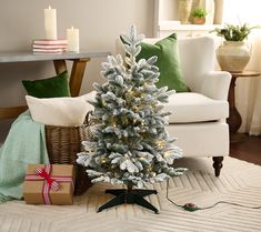 a small christmas tree sitting on top of a white rug