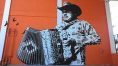 a mural of a man holding an accordion