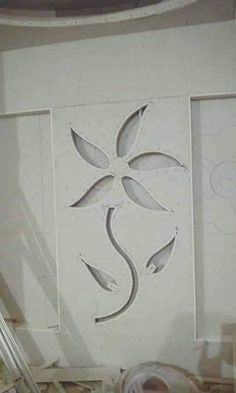 the wall is covered in white paper and has been cut out to look like flowers