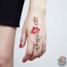 a woman's hand with a flower tattoo on it