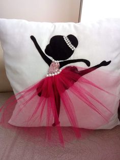 a pillow that has a ballerina on it