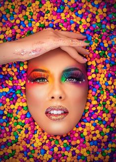 a woman's face is surrounded by colorful candies and sprinkles