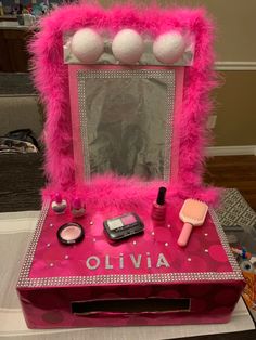 the vanity is decorated with pink fur and makeup items, including a cell phone on it