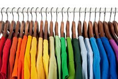 a rack with many different colored shirts hanging from it's hooks and clothes pins