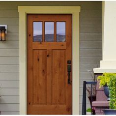 a wooden door on the side of a house