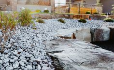 there is a rock garden in front of the house