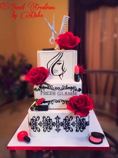 a three tiered cake with red roses and scissors on top is decorated in black and white