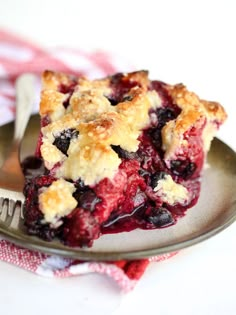 a slice of blueberry pie on a plate with a fork