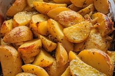 cooked potatoes in a pan with seasoning on top