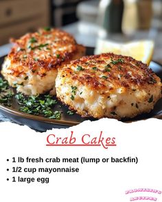 crab cakes on a plate with lemon wedges