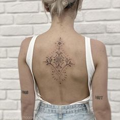 a woman with a tattoo on her back