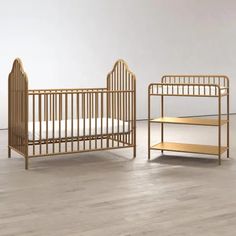 a baby crib next to an infant bed