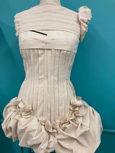 a dress made out of white fabric with ruffles