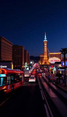 a city street filled with lots of traffic and tall buildings in the background at night