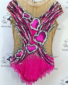 a woman's leotard top with hearts and sequins on it