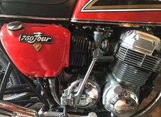 a red motorcycle engine with the number 750 four on it's front end and side