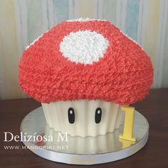 there is a cupcake with a red mushroom on it