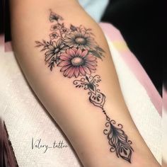 a woman's arm with flowers on it