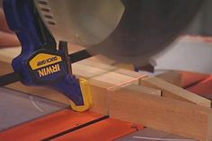 a person using a circular saw to cut wood