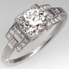 an antique style diamond ring with baguetts and side stones on the sidestones