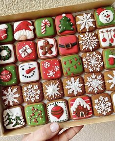 a box filled with lots of decorated cookies