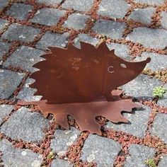 a metal hedgehog is sitting on the ground