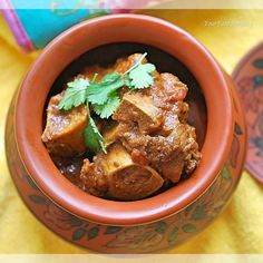 a small bowl filled with meat and garnished with cilantro