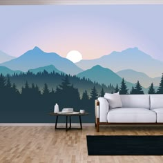 a living room with a couch, coffee table and mountain scene wall mural on the wall