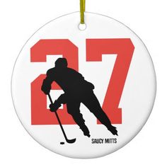 a white ornament with the number seventy on it and a hockey player holding a stick