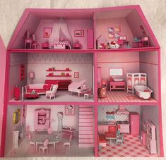 a pink dollhouse with furniture and accessories in the inside, outside and inside rooms