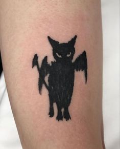 a black cat tattoo on the arm