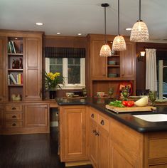 a kitchen filled with lots of wooden cabinets and counter top space next to a window